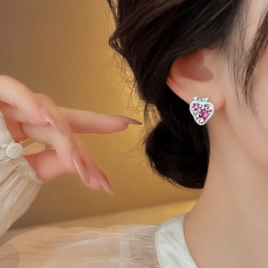 Sparkling pink zircon strawberry stud earrings shown on model for elegant fashion look.