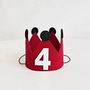 Close-up of red felt birthday crown with white number 4 and black elastic strap