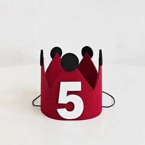 Detailed view of red felt birthday crown with black polka dots and white number 5