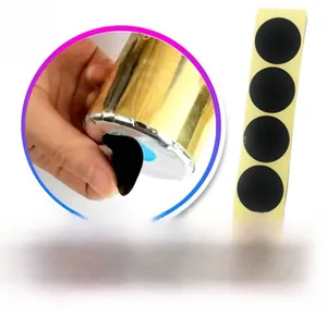 Close-up of black stickers used to seal and hide colors for gender reveal party poppers