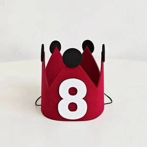Macro detail of red felt birthday crown with number eight and elastic strap