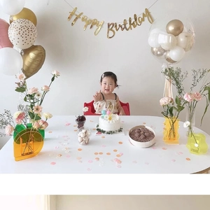Colorful acrylic wave vases with Happy Birthday banner for festive party home decoration
