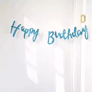 Detail of light blue Happy Birthday letter banner hanging on a white door for party decoration