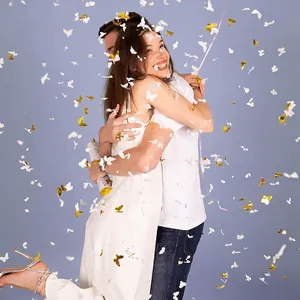 Handheld wedding confetti cannon with gold and white butterfly-shaped paper decorations