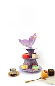 Three-tier mermaid tail cupcake stand featuring purple scales and marine decorations