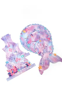 Flat lay view of 3-tier mermaid tail cupcake stand components with scale patterns