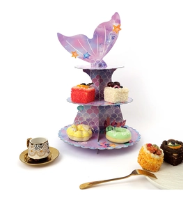 Three-tier mermaid theme cupcake stand with purple fish tail top and scale patterns