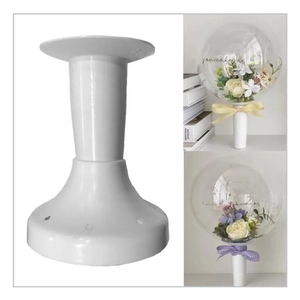 Close-up of a white plastic balloon stand base with pole for party table decorations