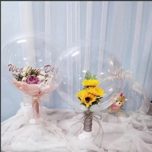 Detail of transparent bobo balloons with interior artificial roses and Wedding Day lettering