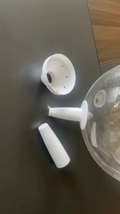 Detailed parts of balloon stand including star-patterned white base and clear plastic dome