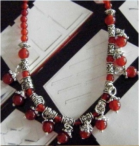Close-up of red agate beads with retro silver flower spacers for DIY jewelry