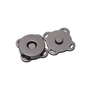 Detail of gunmetal alloy magnetic snaps for sewing on bags and apparel accessories