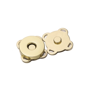 Close-up of golden alloy flower-shaped magnetic button fasteners for bags and clothing