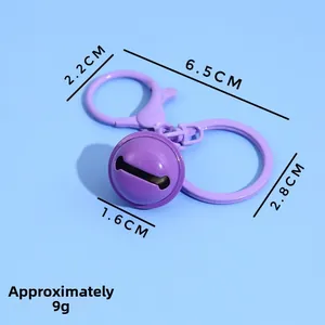 Detail view of purple bell keychain with hooks and rings showing exact 6.5cm dimensions