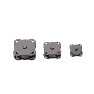 Close-up of black nickel magnetic plum blossom buttons for sewing on bags and clothes