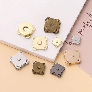 Detailed view of various metal magnetic buttons in gold, silver, bronze, and gunmetal finishes