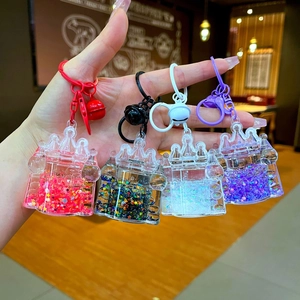 Whimsical liquid glitter castle keychains in red, black, white, and purple variants