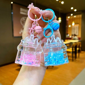Luminous fairy castle quicksand keychain with liquid glitter and bells in pink and blue