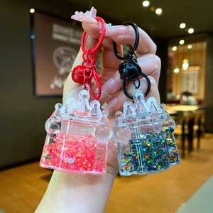Close-up of castle-shaped liquid sand keychains with colorful star sequins and bells