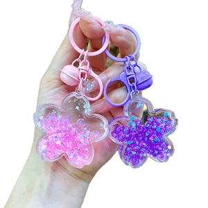 Luminous cherry blossom keychain with liquid quicksand glitter and acrylic flower petals
