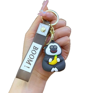 Cute gray gorilla keychain holding a banana with a brown silicone BOOM! wrist strap