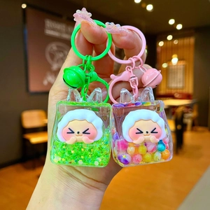 Close-up of liquid quicksand acrylic keychains with cute cartoon figures and colorful beads