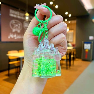 Macro shot of liquid castle keychain with bright green glitter and star sequins