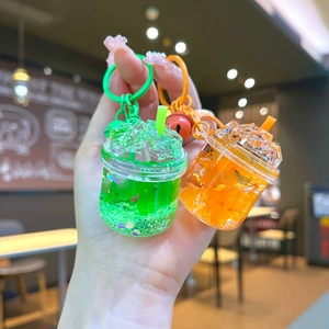 Glow-in-the-dark iceberg liquid quicksand keychains in strawberry green and orange colors