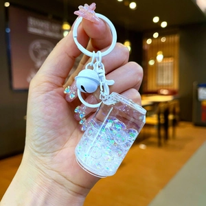Handheld creative cola can keychain with glowing colorful beads and a white bell charm