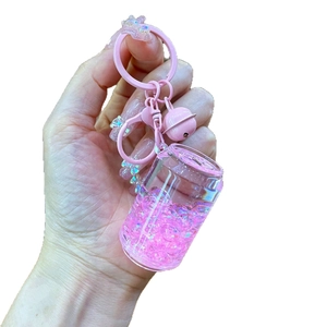 Pink liquid quicksand soda bottle keychain with glitter, small bell and metal clip