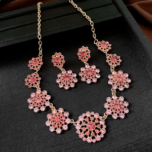 Detailed view of vintage jewelry set with pink crystal hollow flower necklace and earrings
