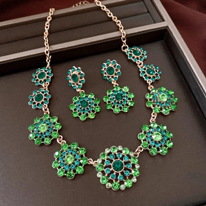 Detailed macro view of the luxury vintage green rhinestone flower necklace and earrings set