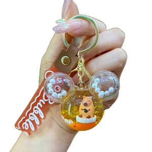 Cute Capybara liquid quicksand keychain with Mickey-shaped pendant and orange strap