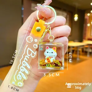 Maneki Neko liquid keychain detail with lucky cat figurine and golden glitter inside