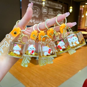 Cute Maneki Neko lucky cat liquid quicksand keychains with gold foil and silicone straps