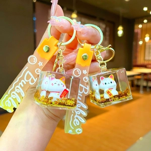 Creative liquid quicksand keychain with cute white fortune cats and golden glitters