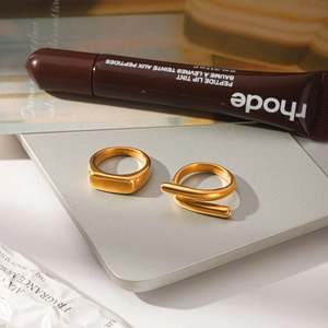 Lifestyle close-up of golden titanium steel crossover line ring with diamond detail
