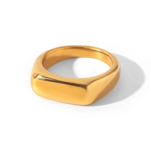 Close-up detail of a smooth polished gold-plated titanium steel signet ring with soft shadow