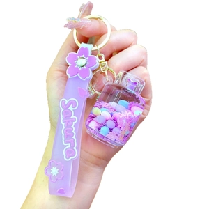 Lavender Sakura wristlet keychain with transparent oil bottle and pink snowflake glitter