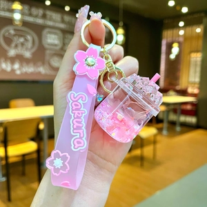 Macro detail of a pink Sakura oil-filled liquid quicksand keychain with silicone strap