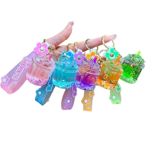 Set of five colorful bubble tea acrylic liquid keychains with Sakura floral charms