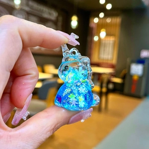 Close-up of a blue unicorn glitter charm with stars and snowflake sequins details