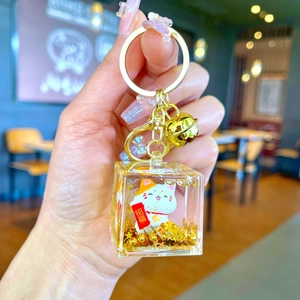 Golden Maneki Neko liquid quicksand keychain with lucky cat figurine and bell