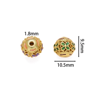 Detailed size view of gold cloisonné enamel hollow beads with purple and green floral motifs