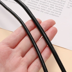 Macro detail of black PU leather cord with fine stitching for bag handle DIY craft