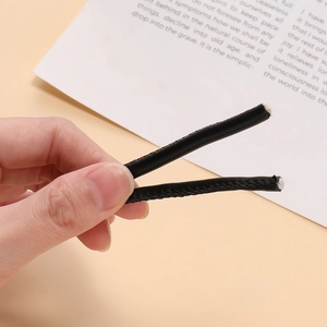 Detail shot of 5mm black braided leather cord showing the inner core and stitching