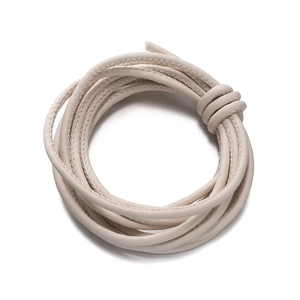 Detailed close-up of beige braided PU leather cord with fine stitching for DIY bag straps