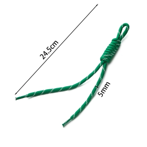 Detail of 24.5cm green braided cord with white dotted pattern and plastic aglets