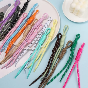 Flat lay of colorful braided polyester cords for DIY crafts in various vibrant colors
