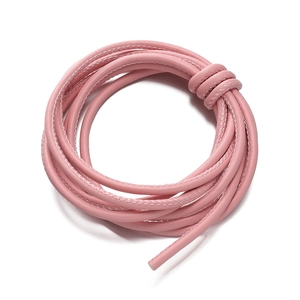 Detailed close-up of pink braided PU leather cord with fine white stitching for DIY crafts